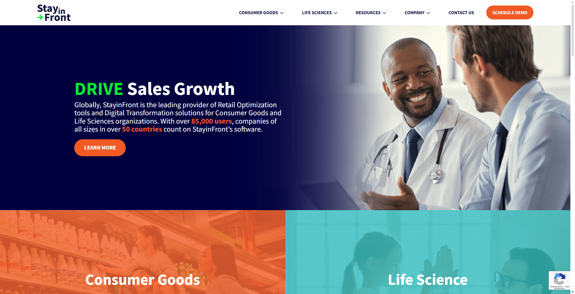 Two men in lab coats smile and converse in a bright office. StayinFront 2026 Field Sales Software site with menus and demo button shown.