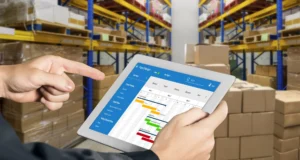 In a warehouse lined with shelves and boxes - Order Management System Vendors