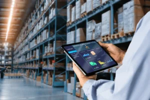 In a spacious warehouse with tall shelves of boxes - Wholesale Order Management System