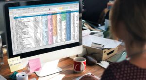 An office worker reviews a vibrant spreadsheet - Order Management Workflow