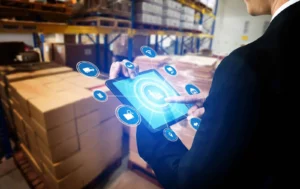 Business professional using a tablet in a warehouse with boxes- Order Management Process 