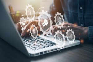 Business professional typing on a laptop - NuOrder Competitors