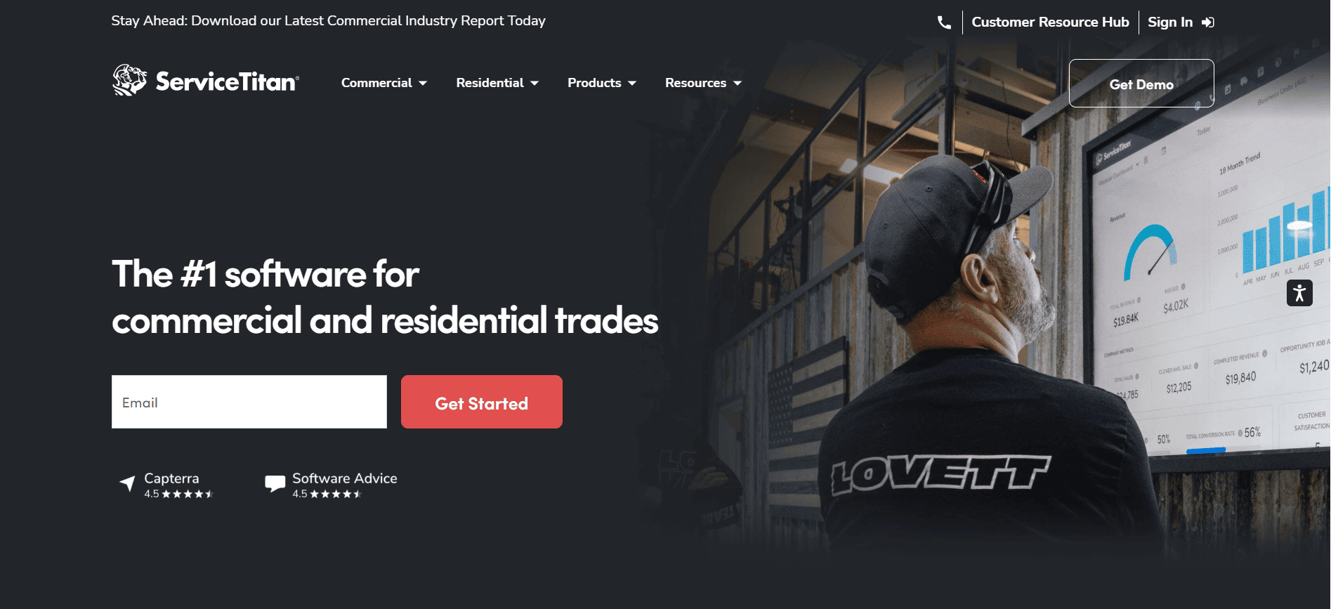 ServiceTitan homepage with a man in a cap viewing charts on a large screen, headline text, email entry field, and demo/get started buttons.